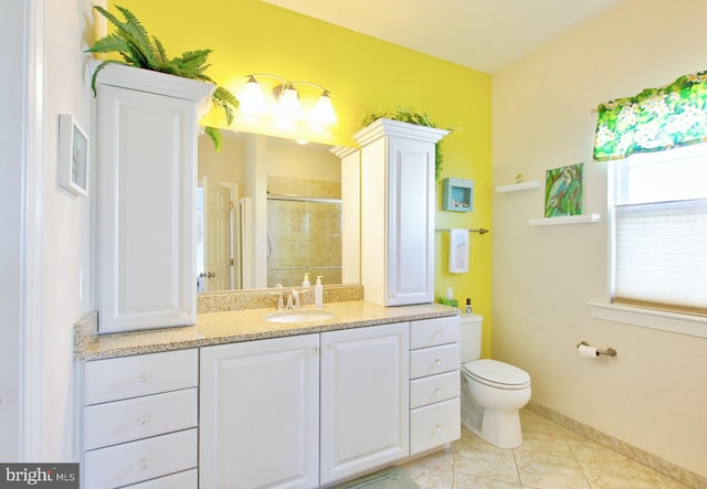 full bathroom featuring toilet, a stall shower, tile patterned flooring, baseboards, and vanity