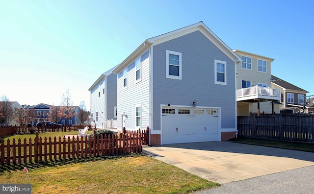 view of home's exterior with brick siding, fence, concrete driveway, a yard, and an attached garage