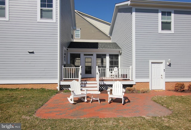 back of house with a deck, a patio area, a sunroom, and crawl space