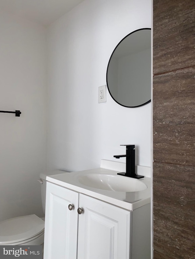 bathroom with toilet and vanity