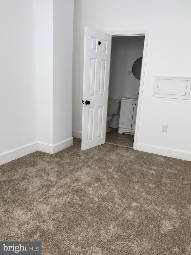 unfurnished bedroom featuring carpet and baseboards