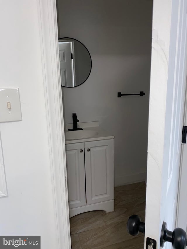 bathroom featuring wood finished floors and vanity