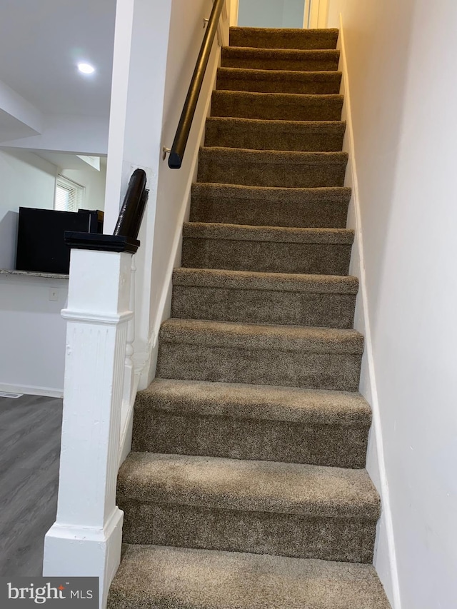 staircase featuring wood finished floors