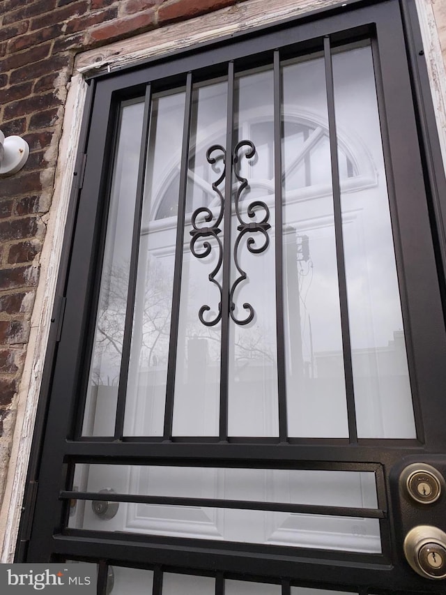 property entrance featuring brick siding