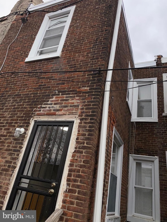 view of side of property featuring brick siding