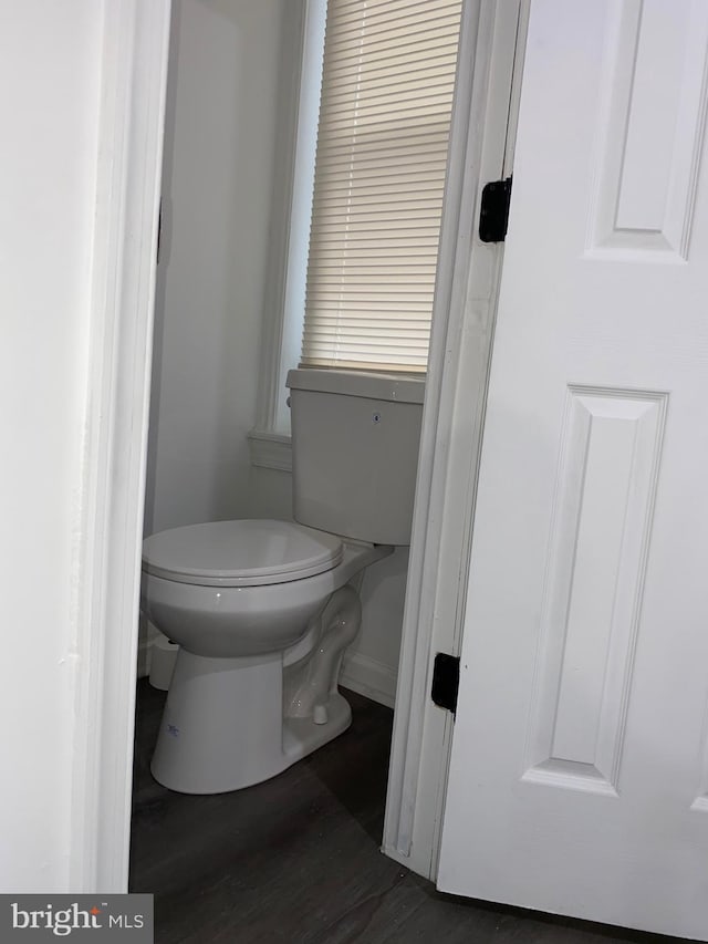 bathroom with toilet and wood finished floors