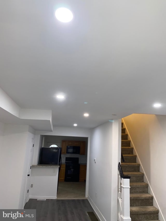 interior space featuring baseboards, visible vents, dark wood-style floors, stairway, and recessed lighting