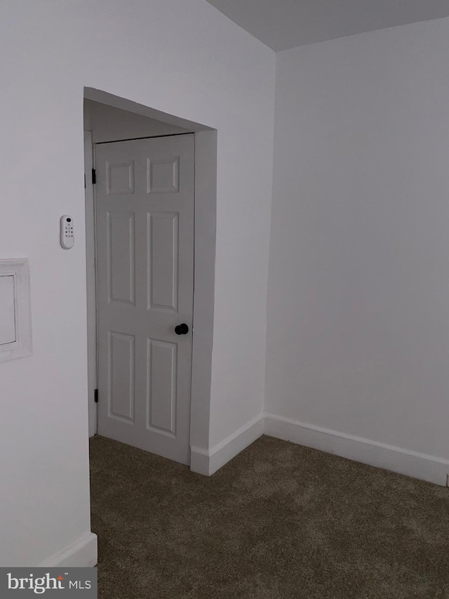 carpeted empty room with baseboards