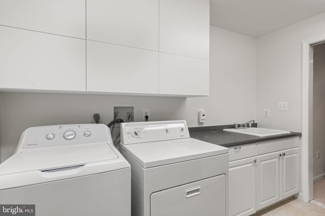 laundry room featuring a sink, cabinet space, and washing machine and dryer