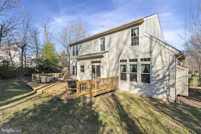 rear view of property with a lawn and a wooden deck