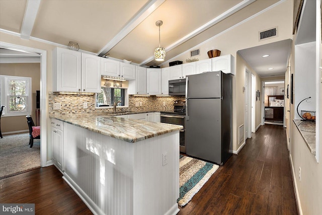 kitchen featuring visible vents, lofted ceiling with beams, tasteful backsplash, stainless steel appliances, and a peninsula