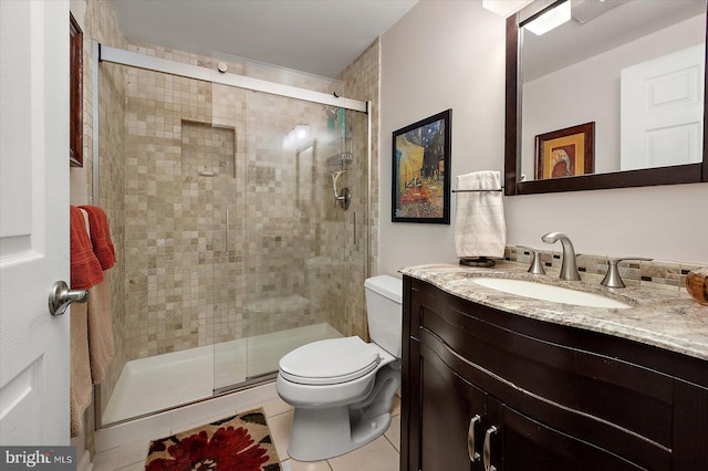 full bath featuring tile patterned floors, a shower stall, toilet, and vanity