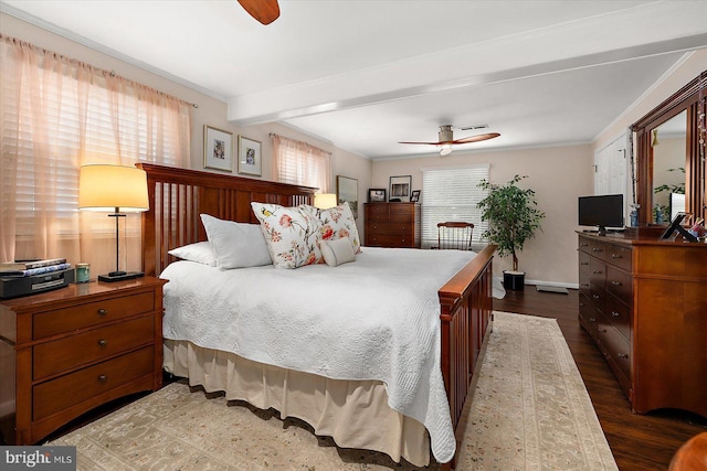 bedroom featuring a ceiling fan, crown molding, baseboards, and wood finished floors