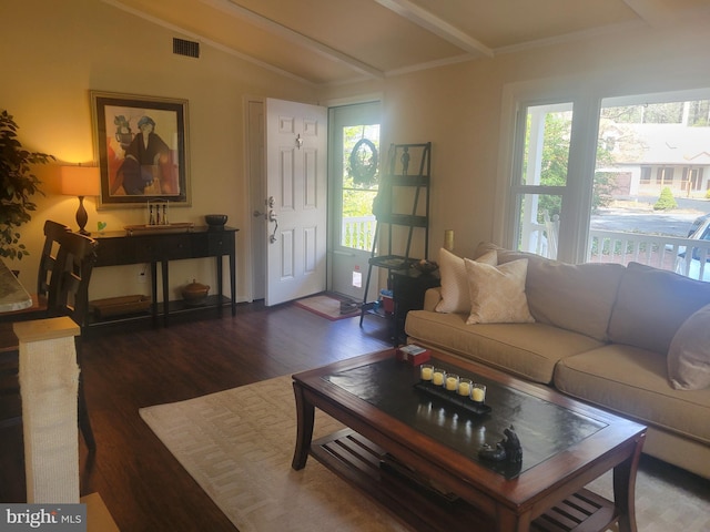 living area featuring vaulted ceiling with beams, wood finished floors, and visible vents