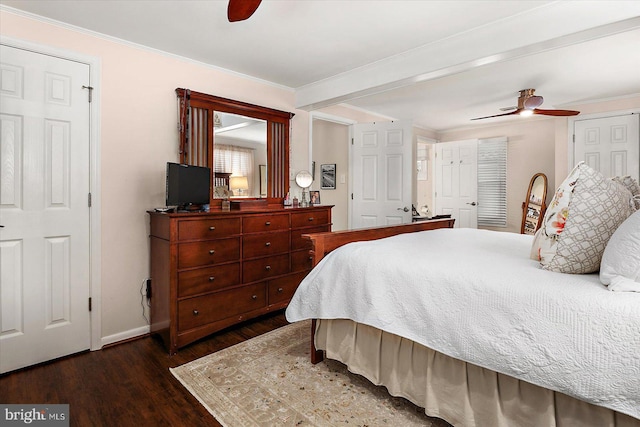 bedroom with dark wood-style floors, ceiling fan, crown molding, and baseboards