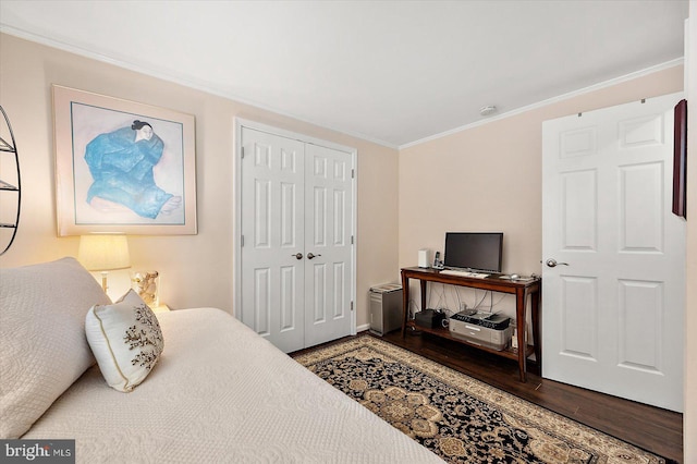 bedroom featuring a closet, crown molding, and wood finished floors