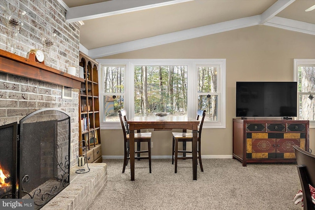 interior space featuring a fireplace, vaulted ceiling with beams, and baseboards