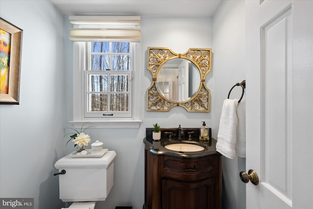 half bathroom featuring toilet and vanity