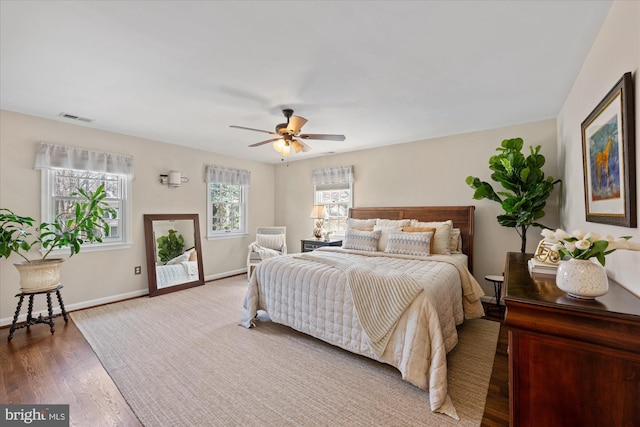 bedroom with visible vents, a ceiling fan, access to outside, wood finished floors, and baseboards