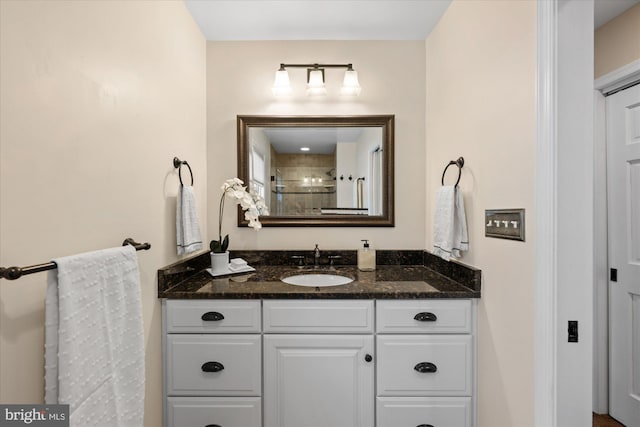 full bath featuring vanity and a tile shower