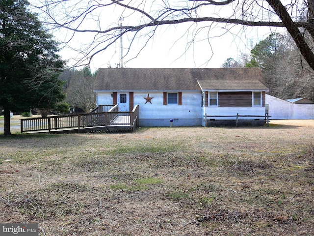 view of front of house featuring crawl space, a deck, a front lawn, and a shingled roof