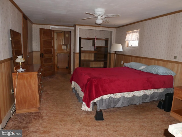 carpeted bedroom with wallpapered walls, ornamental molding, and wainscoting