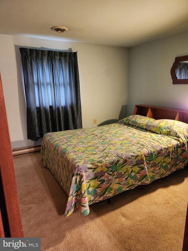 bedroom featuring a baseboard radiator, visible vents, and carpet flooring