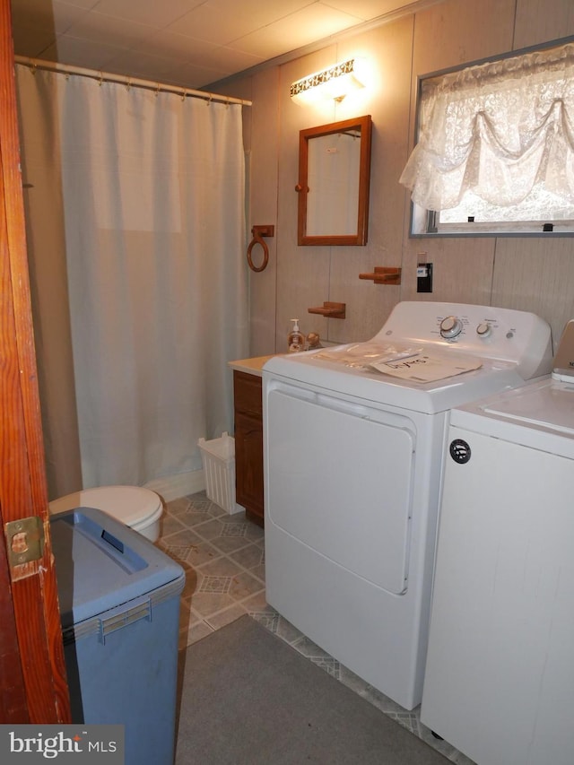 clothes washing area featuring laundry area, separate washer and dryer, and tile patterned floors