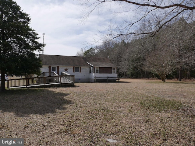 view of front of house featuring crawl space, a wooden deck, and a front yard