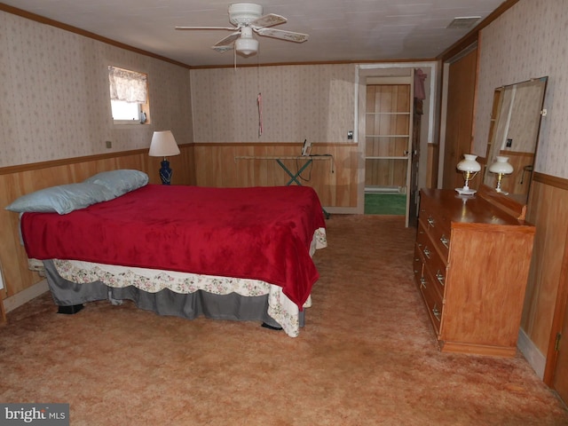 carpeted bedroom featuring a wainscoted wall, wallpapered walls, and ornamental molding