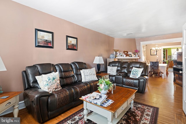 living room featuring light wood-style floors and a chandelier