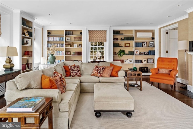 living area featuring built in shelves, wood finished floors, and ornamental molding