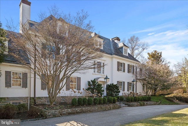 view of home's exterior featuring stucco siding and a chimney