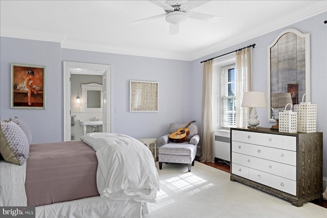 bedroom featuring connected bathroom, wood finished floors, radiator heating unit, and crown molding