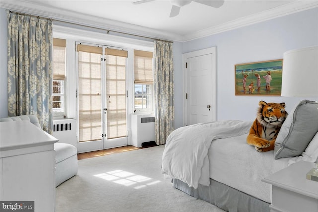 bedroom with french doors, a ceiling fan, radiator heating unit, and crown molding