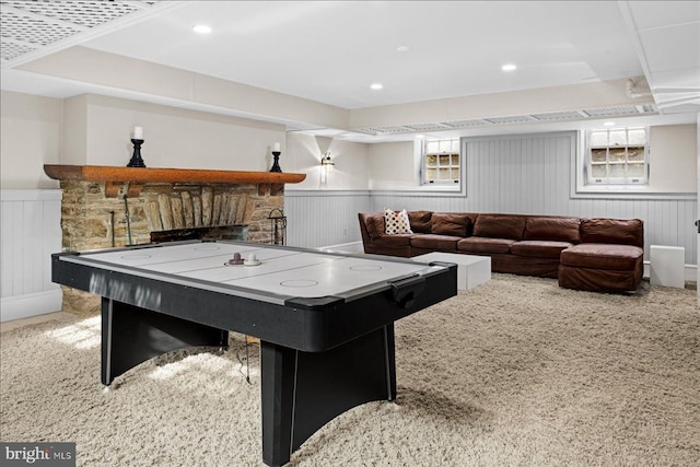 game room featuring recessed lighting, a wainscoted wall, and a stone fireplace