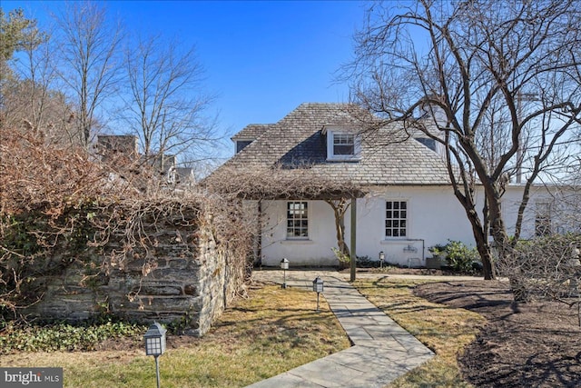 view of front of house featuring a high end roof and stucco siding