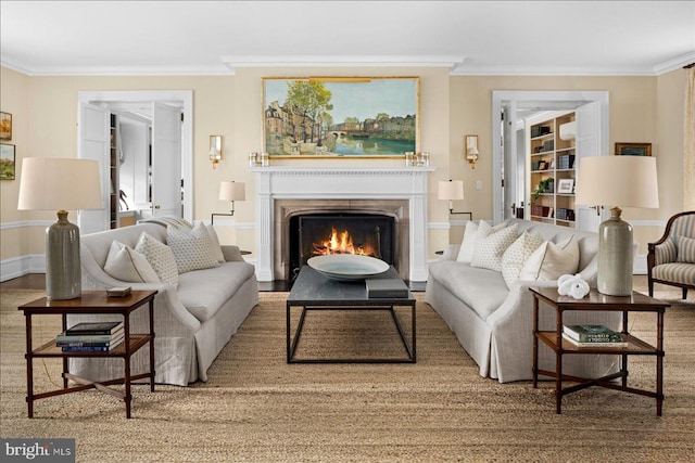 living area with crown molding and a lit fireplace