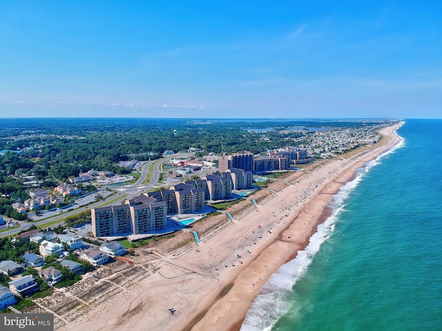 drone / aerial view featuring a water view and a beach view