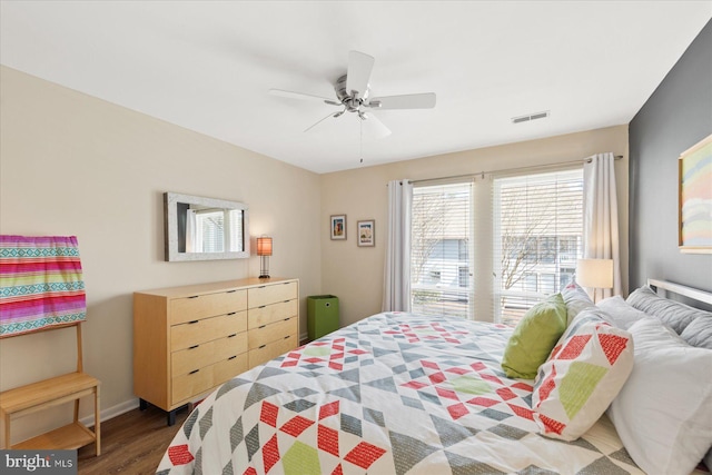 bedroom featuring baseboards, ceiling fan, visible vents, and dark wood-style flooring