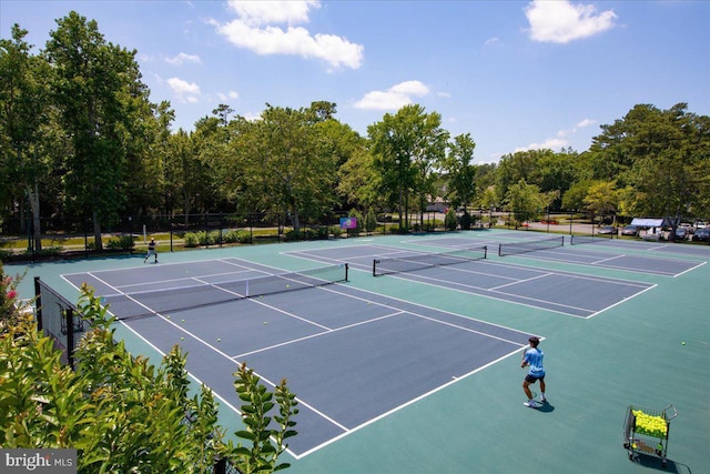 view of tennis court featuring fence