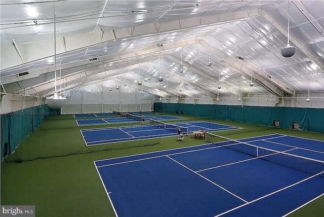 view of tennis court featuring community basketball court and fence