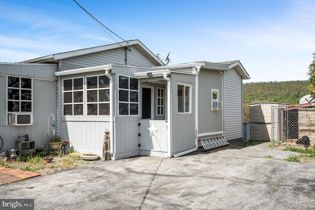 back of house featuring cooling unit