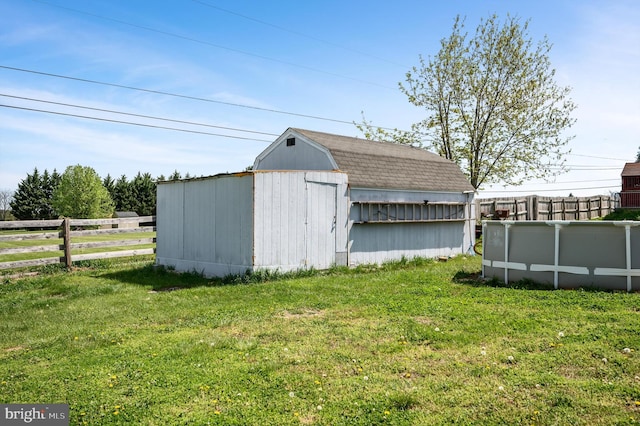 view of outbuilding featuring an outbuilding and fence