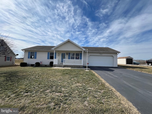 ranch-style home with aphalt driveway, covered porch, a garage, and a front yard