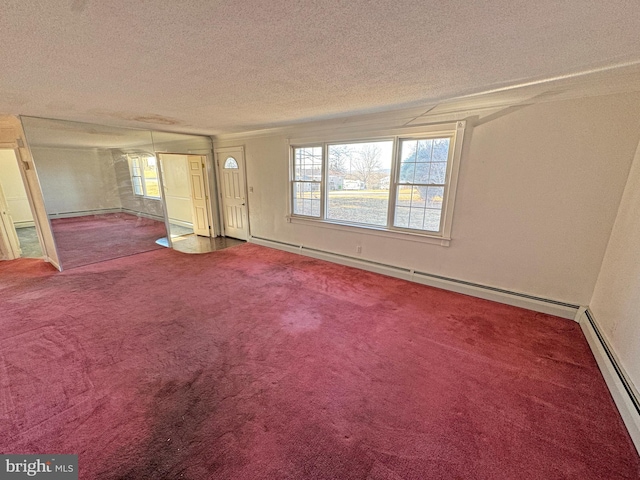 spare room with a textured ceiling, carpet floors, and baseboard heating