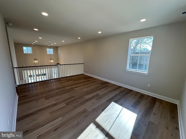 spare room featuring visible vents, baseboards, wood finished floors, and recessed lighting