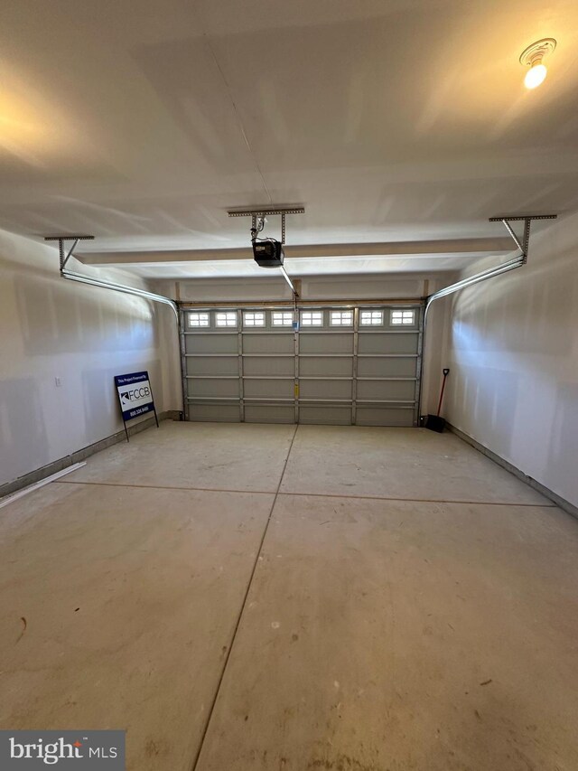 garage featuring baseboards and a garage door opener