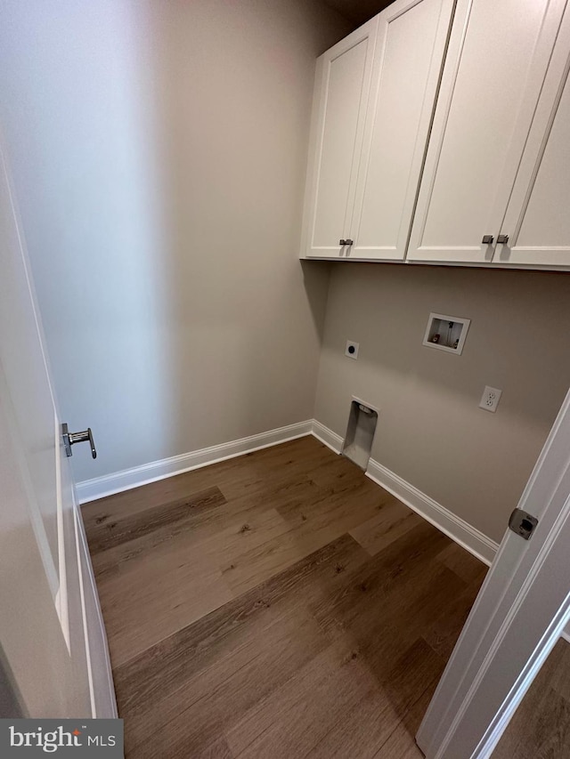 laundry room featuring dark wood finished floors, hookup for a washing machine, electric dryer hookup, and baseboards