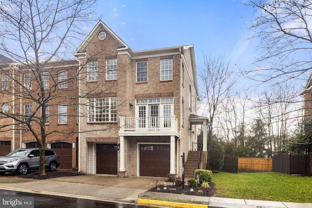 townhome / multi-family property with brick siding, concrete driveway, fence, a garage, and a front lawn